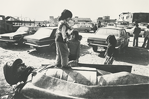 Child standing on a toppled statue during the Iranian Revolution, 1978/1979.