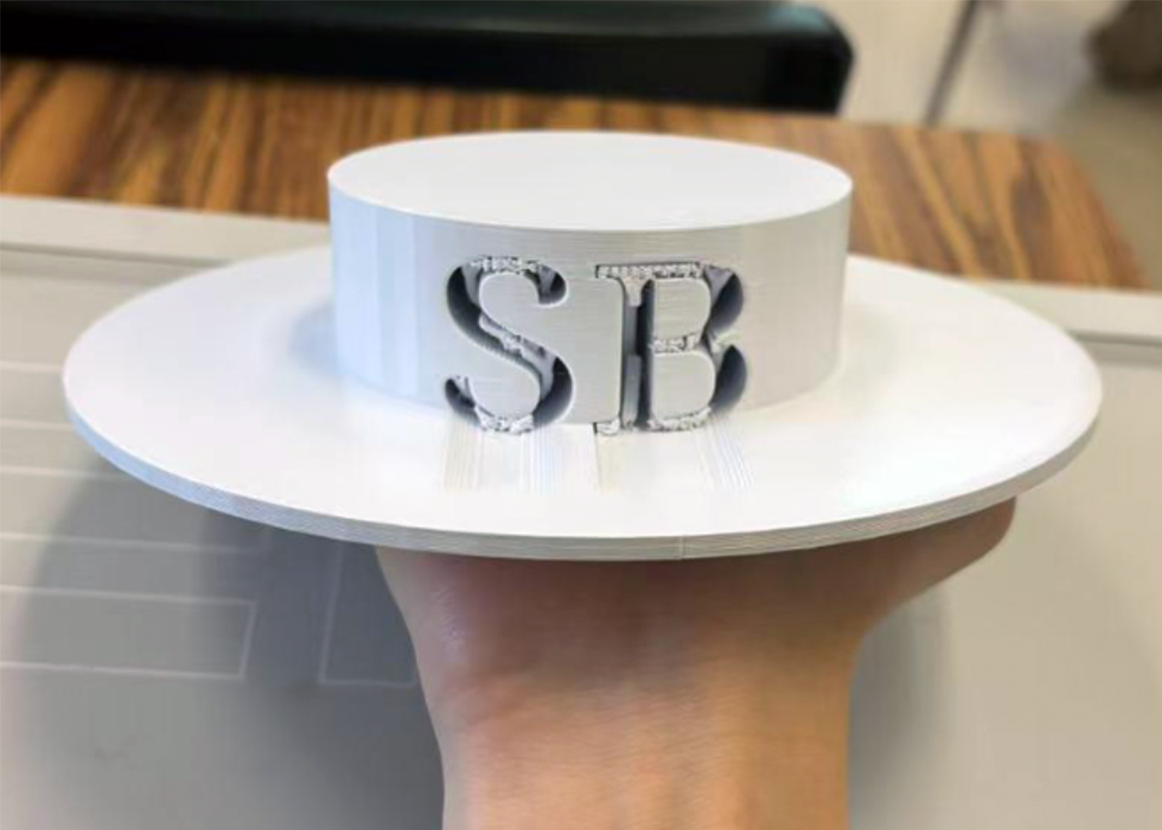 A hand holding the Gaucho hat sculpture