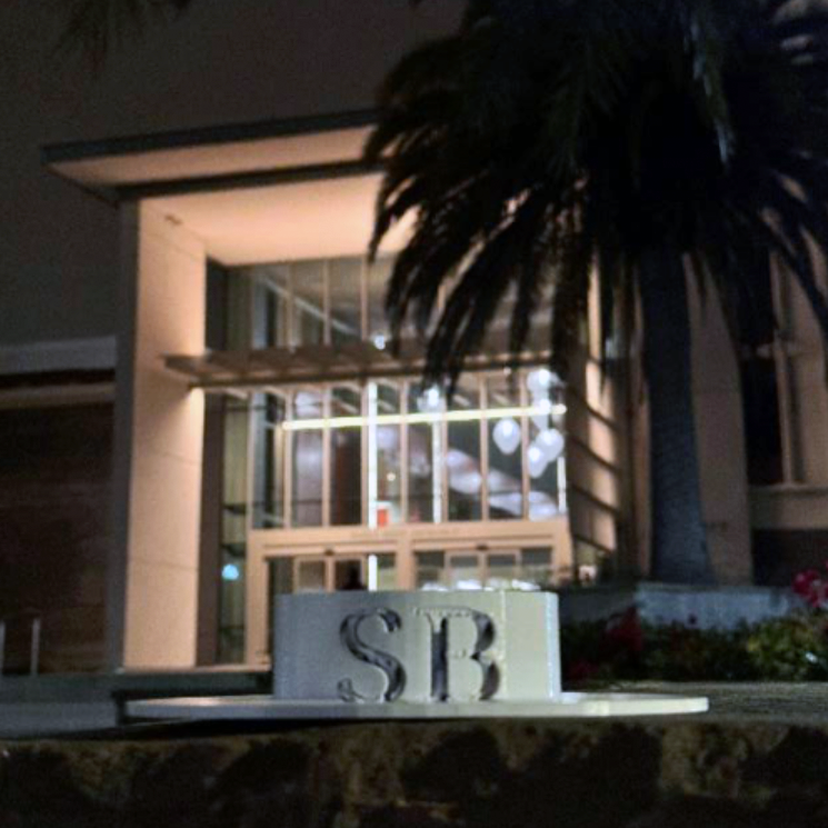 Gaucho hat sculpture in front of the Library's Paseo West entrance at night