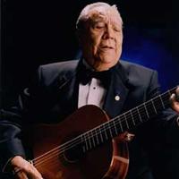 Lalo Guerrero singing and playing the guitar