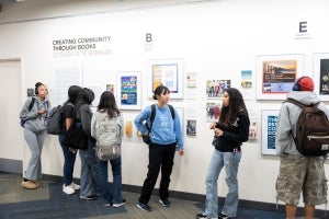 A group of students exploring the Creating Community Through Books exhibition on January 13, 2026, ahead of the UCSB Reads 2026 Book Giveaway to Students. 
